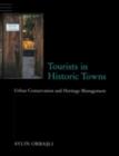 Image for Tourists in historic towns: urban conservation and heritage management